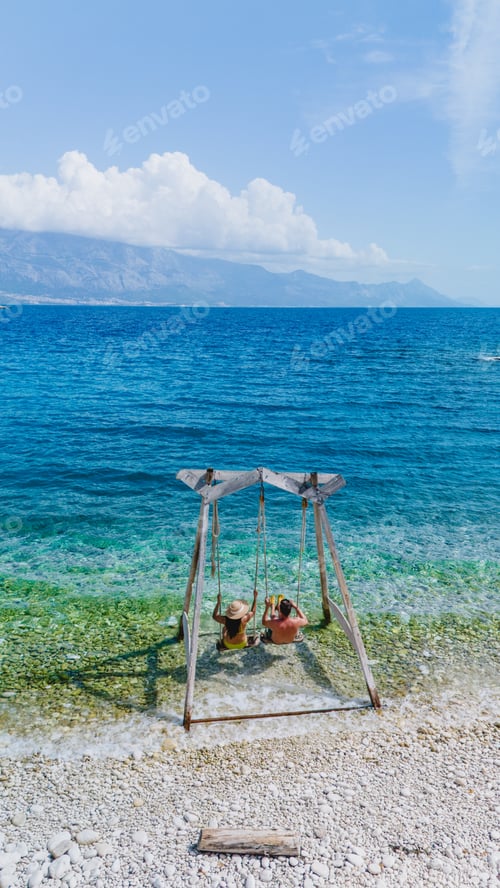 Preview: Relaxing on a wooden swing by the tranquil waters of Brac Island in Croatia on a sunny day