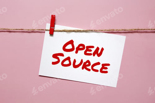 Preview: Sticker with the inscription open source hanging on a rope on a pink background