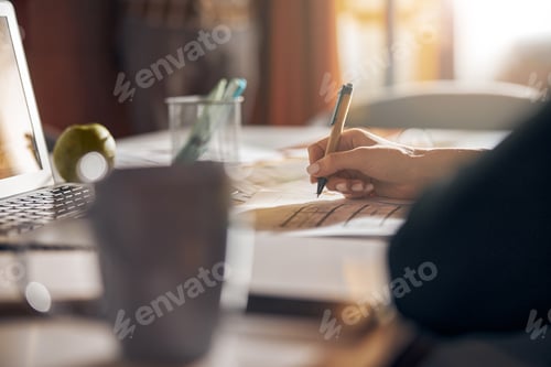 Preview: Experienced draftswoman modifying a building plan with a ball-point pen