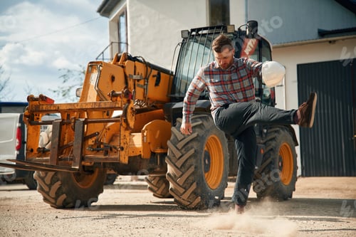 Preview: Mad, angry emotion. Man is with tractor. Agricultural worker