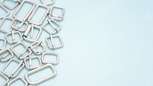Preview: Metal accessories and supplies for bags, backpacks and sewing laying on a light blue background