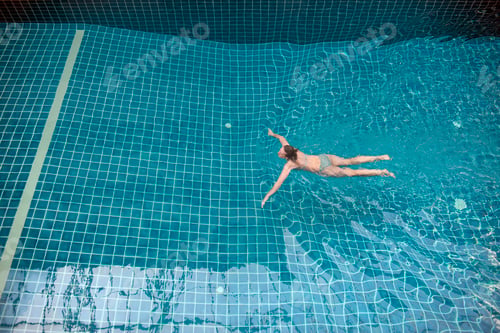 Preview: Woman swimming in pool, high angle