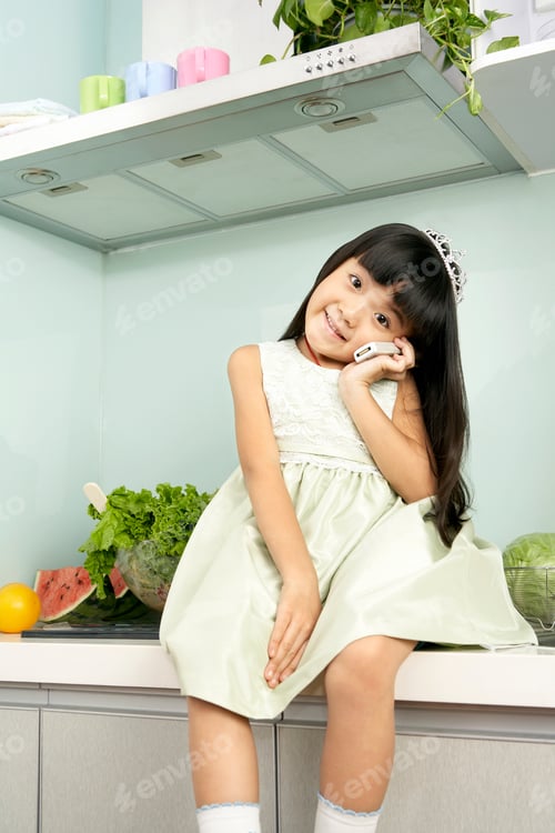 Preview: Smiling Girl With Tiara Posing in Kitchen