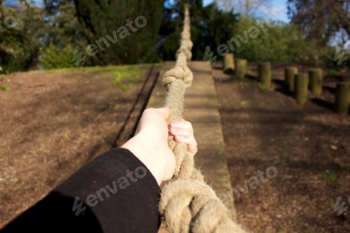 Preview: Woman’s hand holding onto and pulling rope in tug of war