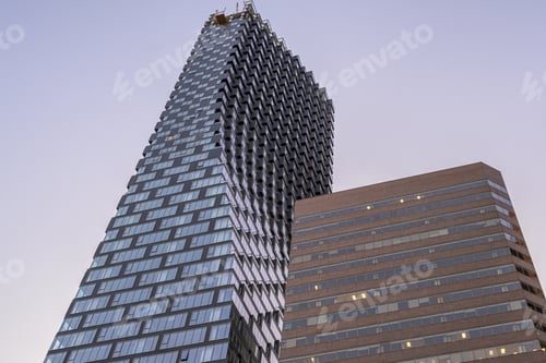 Preview: Low angle shot of Telus Sky tower captured under the blue sky in Calgary, Alberta, Canada