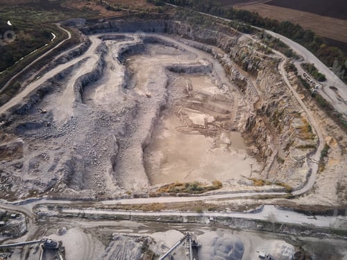 Preview: Aerial view of Slope operating granite quarry with mining equipment on ledges