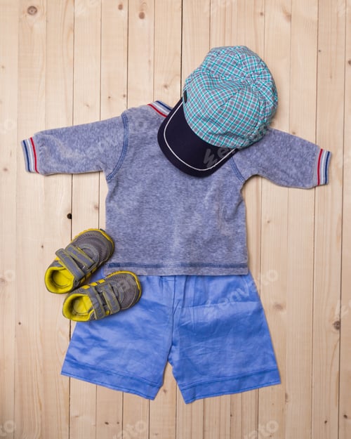 Preview: baby clothes for boys on wooden background