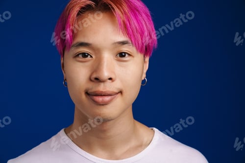 Preview: Asian boy with pink hair smiling and looking at camera