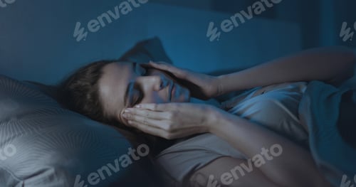Preview: Stressed young woman suffering from insomnia