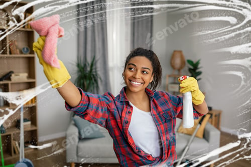 Preview: Glad young black lady in rubber gloves washes mirror with spray, enjoys cleaning in living room