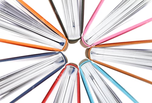 Preview: Top view of colorful books in a circle on white background