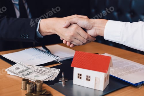 Preview: Home sales agents and buyers work on signing new homes and shaking hands.