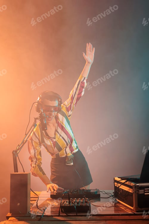Preview: Happy musical artist using mixer to play techno
