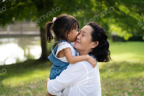 Preview: Adorable aAdorable asian granddasian granddaughter is playing and kissing together with grandmother