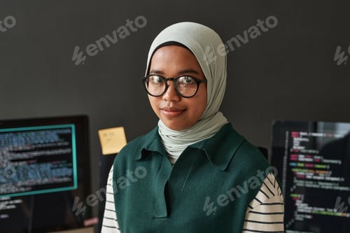 Preview: Young confident IT engineer or software developer in hijab looking at camera