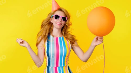 Preview: Excited fashionable woman dancing with balloon having fun for celebrate, entertainment. Redhead lady