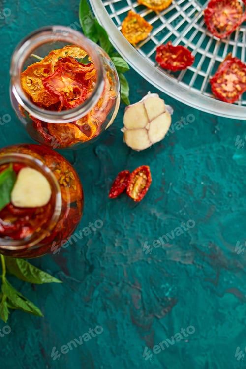 Preview: Homemade sun dried tomatoes with herbs, garlic in olive oil in a glass jar