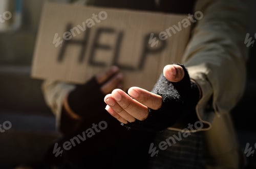 Preview: A homeless man begging for help. Ask for a coin of human mercy on a wooden floor in a public walkway