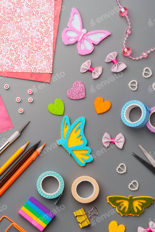 Preview: Crafting materials and tools arranged on a gray surface during a creative project