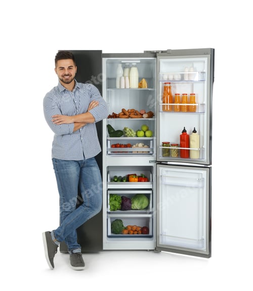 Preview: Young man near open refrigerator on white background