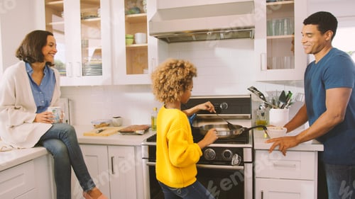 Preview: Daughter Preparing Meal in Kitchen Watched By Parents