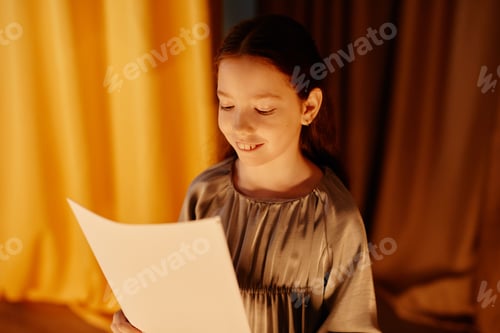 Preview: Smiling Girl Holding Paper for Presentation Evening Scene