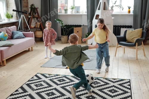 Preview: Children Playfully Kick a Soccer Ball Indoors