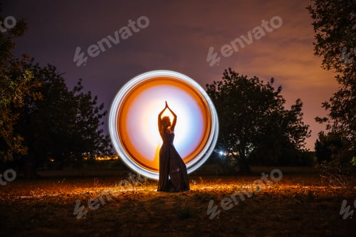Preview: Female silhouette in glowing circle in nature