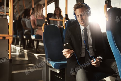 Preview: Young businessman listening to music on his morning commute