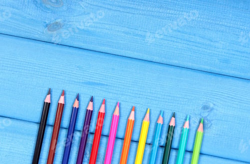 Preview: Colorful crayons, school accessories, copy space for text on blue boards