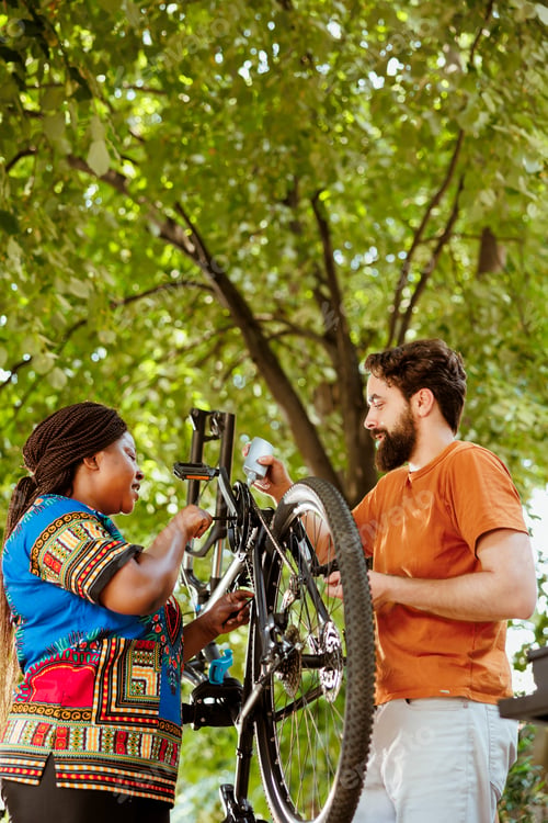 Preview: Couple servicing bicycle outside