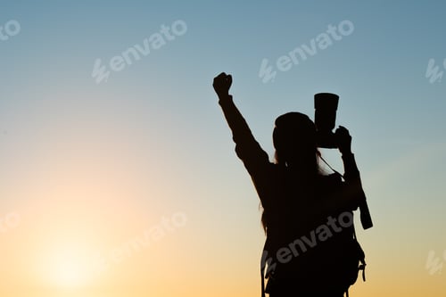 Preview: Silhouette of tourist woman standing in the mountain