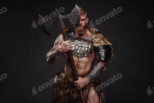 Preview: Brutal tattooed warrior wearing light armour and fur holding two-handed axe in dark studio