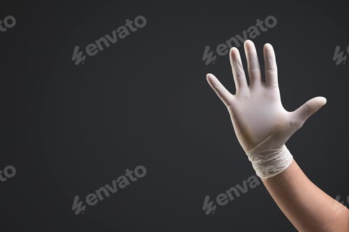 Preview: Hand in Protective Glove Against Dark Background