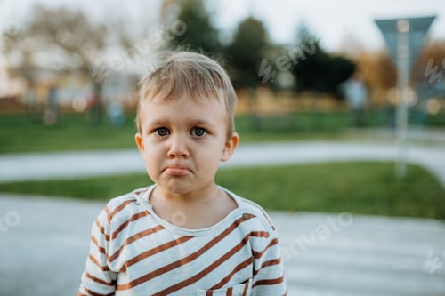 Preview: Sad little boy crying outside in park