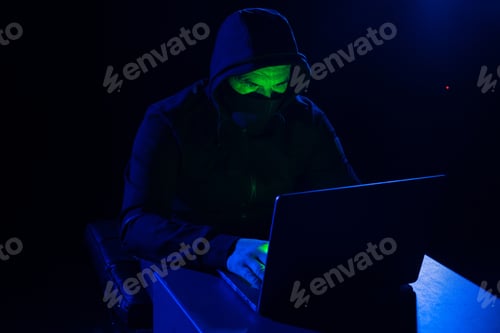 Preview: Hacker hiding his face on dark background