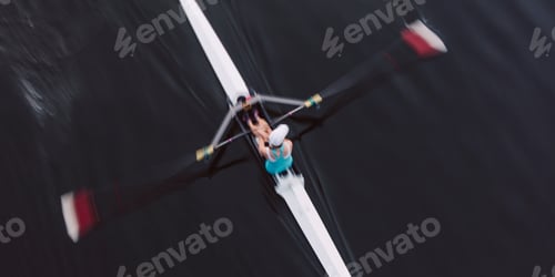 Preview: Overhead view of an oarsman in a single scull boat on calm water mid stroke, motion blur.