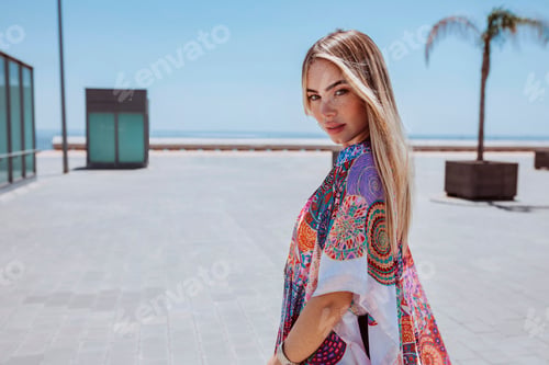 Preview: Young blond woman posing outdoors near beach