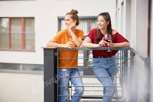 Preview: Two girls spending time relaxing on balcony