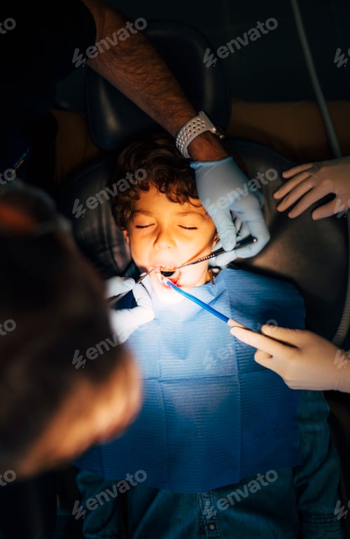 Preview: A child is seen by a dentist.