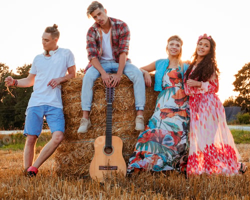 Preview: Hippie friends with guitar in a wheat field
