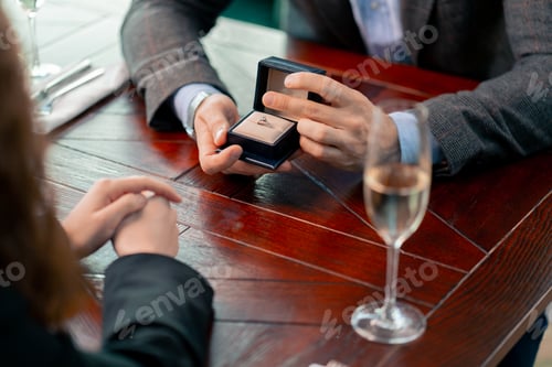 Preview: a date in a restaurant a man proposes to his beloved holds a box with ring and proposes marriage