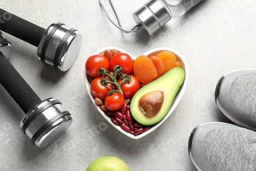 Vista previa: Heart shaped bowl with healthy products and sports equipment on grey background, flat lay