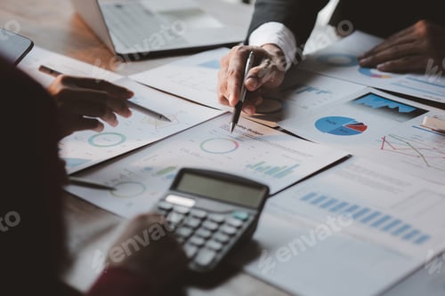 Preview: Group business people are brainstorming together and reviewing the company financial documents that