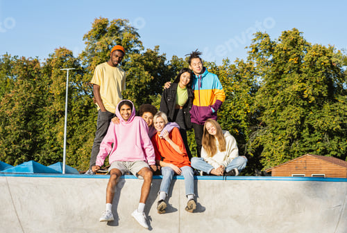 Preview: Multiracial group of young friends bonding outdoors
