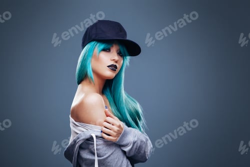 Preview: Young womanwith cyan color hair in hoodie and cap