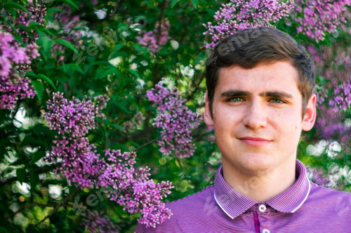 Preview: Defocus smiling caucasian man outdoors portrait. Spring people. Young men in purple shirt on nature