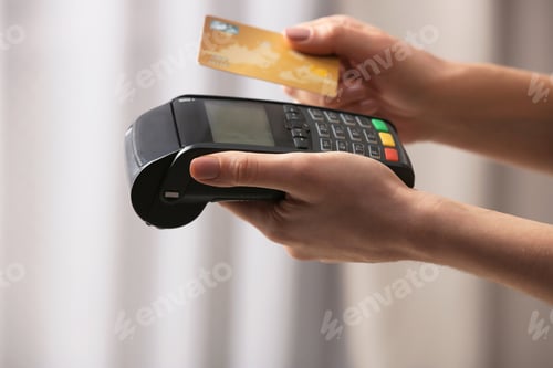Preview: Woman using modern payment terminal indoors, closeup