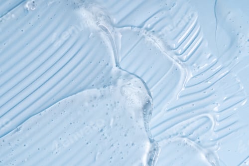 Preview: Liquid gel abstract cosmetic in blue background. Smear of transparent moisturizing product