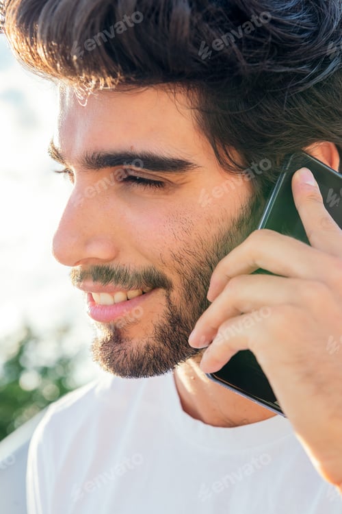 Preview: portrait of a man smiling and talking on his phone